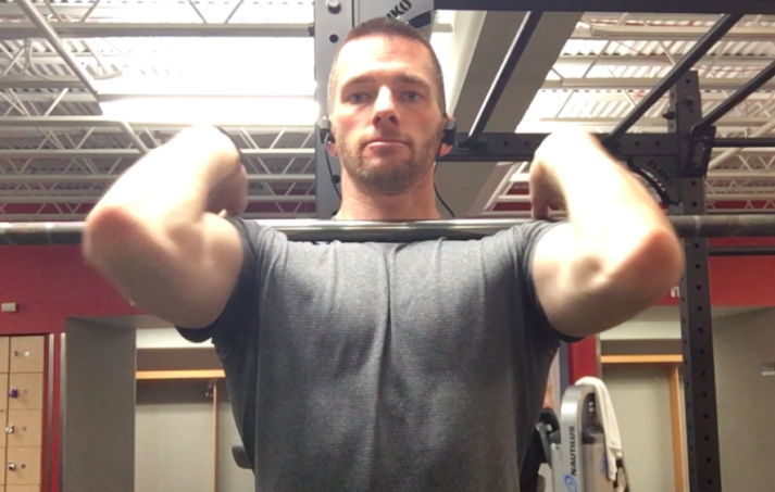 With your chest up and elbows up, grab the bar close to your shoulders